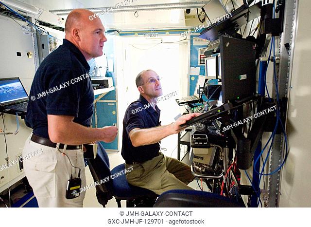 NASA astronaut Don Pettit (seated) and European Space Agency astronaut Andre Kuipers, both Expedition 3031 flight engineers