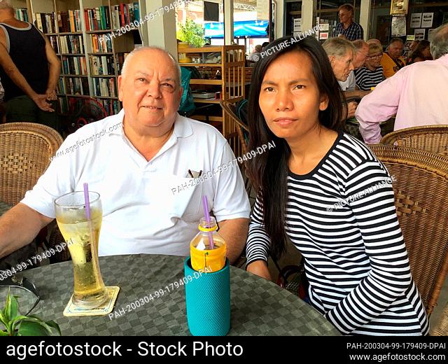 09 February 2020, Thailand, Pattaya: Claus-Peter Lippert sits with his girlfriend Naree Konram at a table in the Evangelical Beginning Center in Pattaya