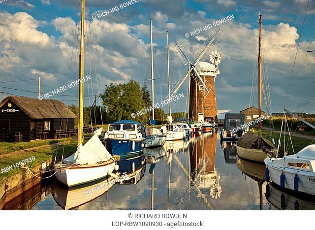 England, Norfolk, Horsey, Relections of Horsey Windpump and boats in Horsey Mere on the Norfolk Broads