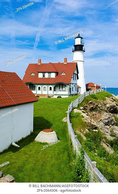 Portland Maine famous Head Light Lighthouse in USA on water with rocks and ocean on cliff