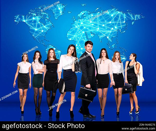 Group of business people over world map behind them. Elements of this image furnished by NASA