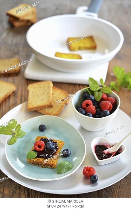 Rusk poor knight with jam and fresh fruits on a tray (vegan)