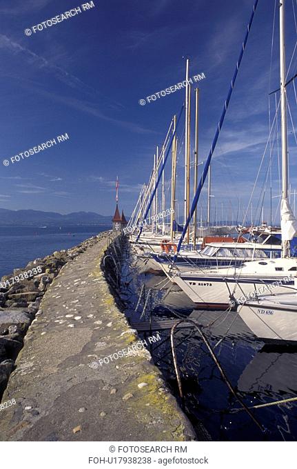 Switzerland, La Cote, Vaud, Lake Geneva, Boats docked in the harbor along the lakefront in the town of Morges on Lac Leman