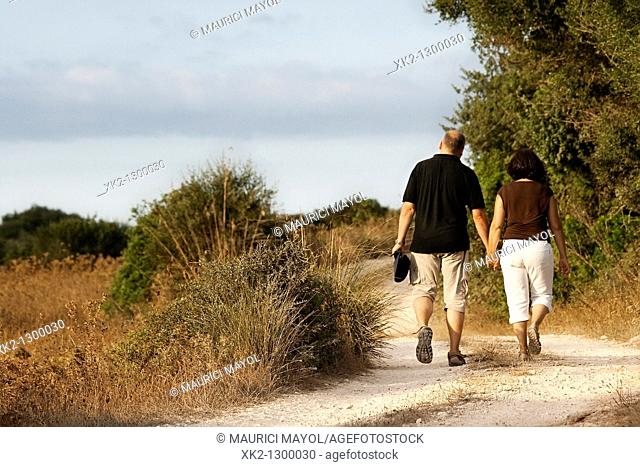 Couple walking in the countryside. Minorca, Balearic Islands, Spain
