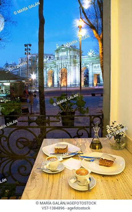 Coffee with cake for two at dusk. Independencia Square, Madrid, Spain