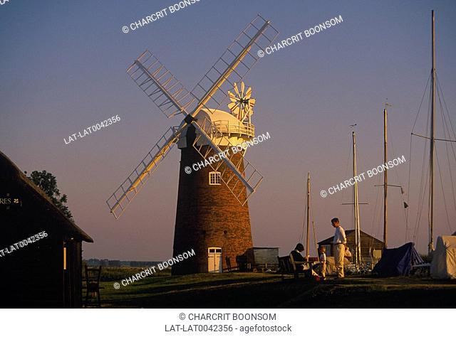 Windmill. National Trust. White paint. Sail frames. River. Boat masts. Family
