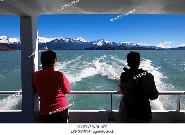 Two women on board a ship on the passage to the glaciers at Lago Argentino, Los Glaciares National Park, near El Calafate, Patagonia, Argentina