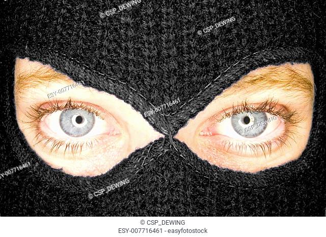A stock photograph of an attractive woman wearing a balaclava