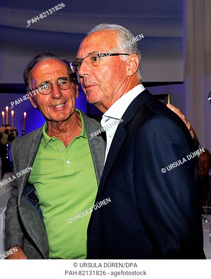 Soccer legend Franz Beckenbauer (r) and his brother Walther enjoying the gala that is being held as part of the 29th Kaiser Cup golf tournament
