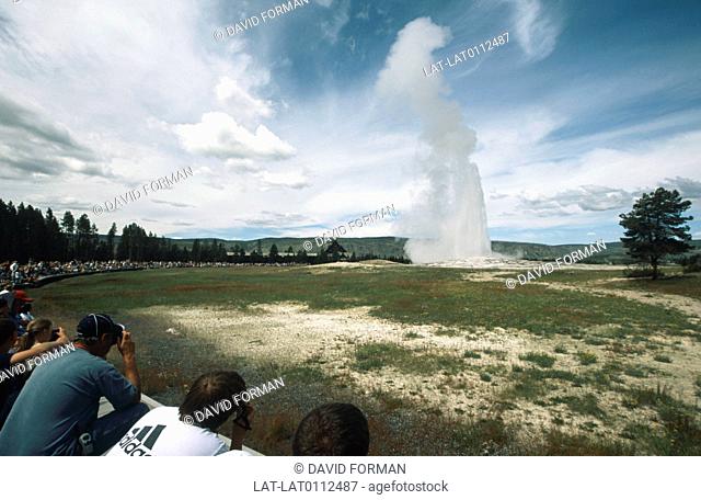 People watching Old Faithful Geyser which erupts approximately every 91 minutes, Geothermal activity in Yellowstone National Park