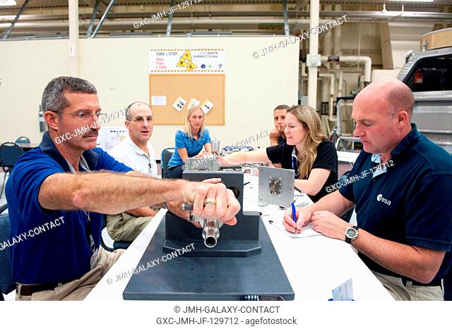 NASA astronaut Dan Burbank (left foreground), Expedition 29 flight engineer and Expedition 30 commander; along with NASA astronaut Don Pettit (left background)...