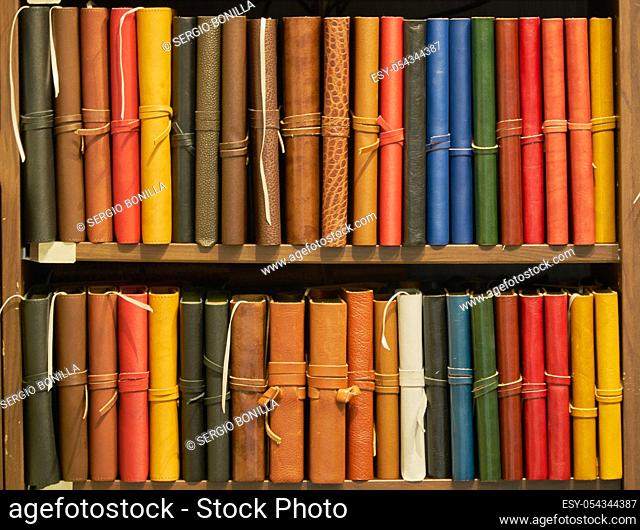 leather bound books of various colors in an antique bookstore