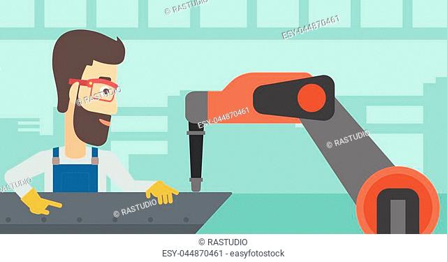 Young caucasian man working on industrial welding robotic arm at the factory. Hipster worker using industrial robotic arm in steel making plant