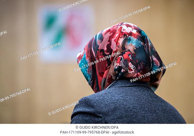 A representative of the council of Muslims stands in front of the federal coat of arms in the higher administrative court in Muenster, Germany, 9 November 2017