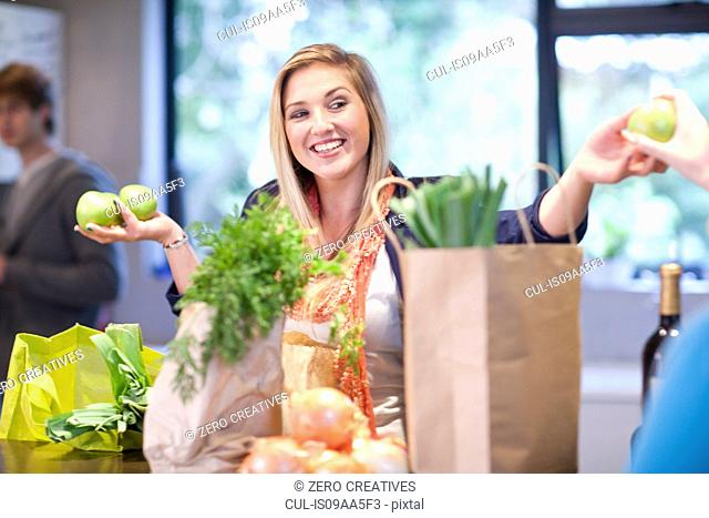 Young woman unpacking groceries
