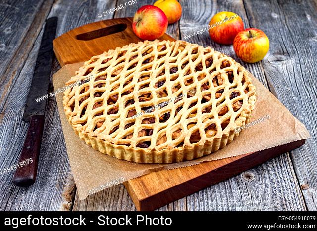 Traditional apple jalousie cake offered as closeup on a modern design wooden board