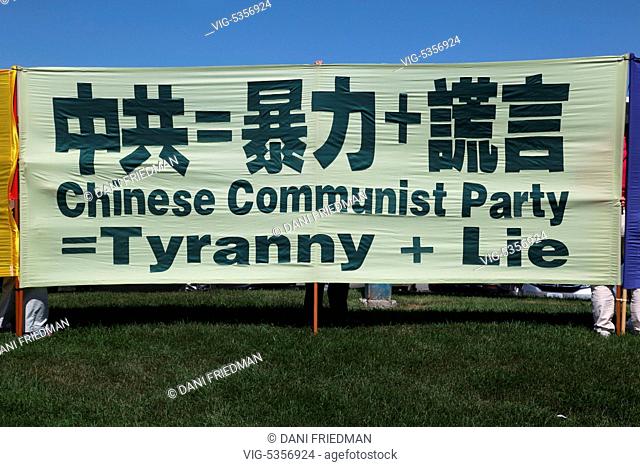 CANADA, MARKHAM, 23.08.2015, Members of the Falun Gong (Falun Dafa) hold a large banner in protest against the Communist Party of China