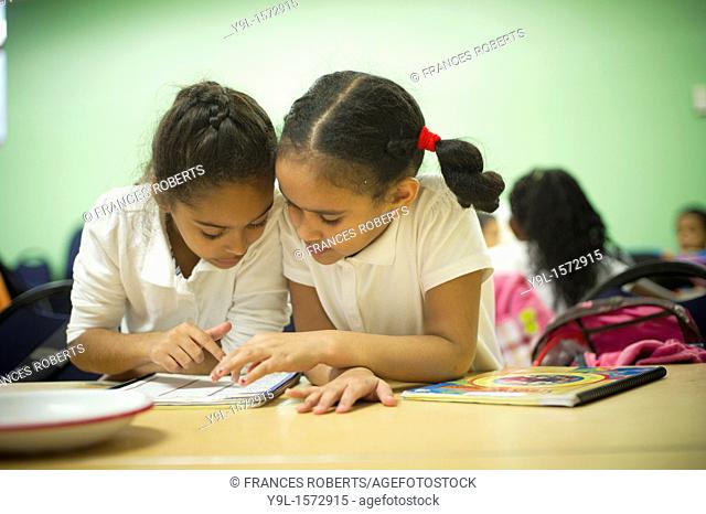 Second and third graders do their homework during the Plant Part Pizza cooking session at Columbia University's Teachers College in New York The gastronomic...