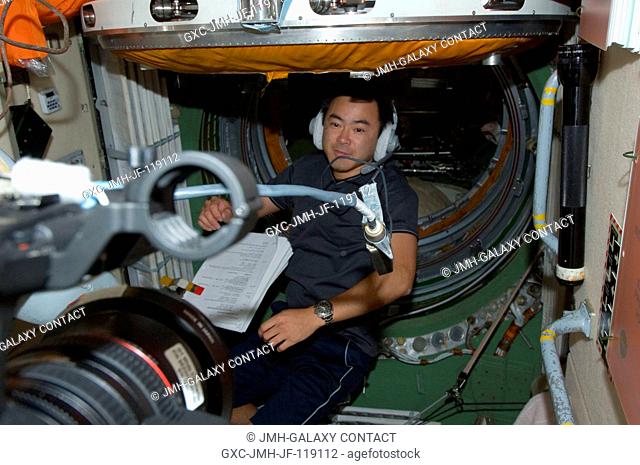 Japan Aerospace Exploration Agency astronaut Aki Hoshide, Expedition 32 flight engineer, wearing a communication headset