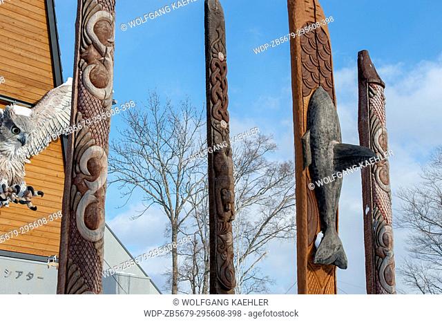 Carved wooden Ainu poles in front of the Ainu performance center in Ainu Kotan, which is a small Ainu village in Akankohan in Akan National Park, Hokkaido