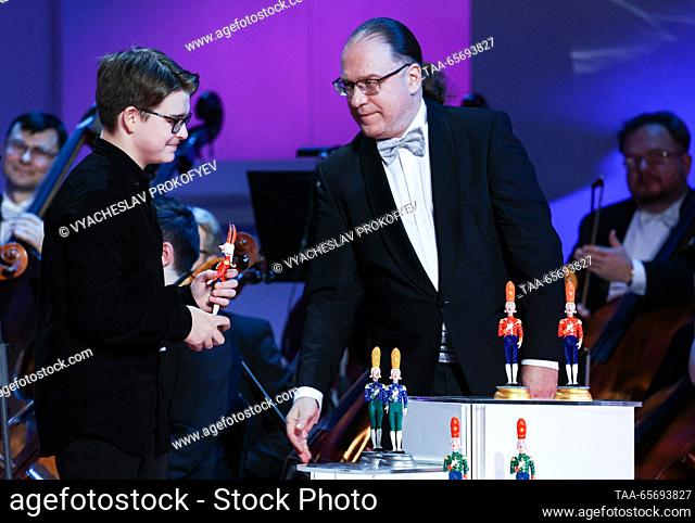 RUSSIA, MOSCOW - DECEMBER 12, 2023: The first place winner in the string category, cellist Mikhail Vasilyev (L), and conductor Kirill Kravtsov attend an award...
