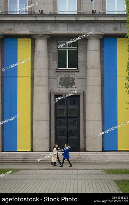 Riga, Latvia, Giant Ukraine flags on a government building and pedestrians