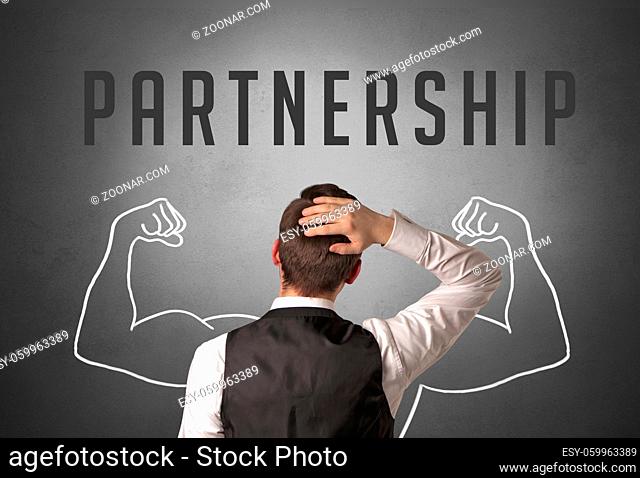 Rear view of a businessman with PARTNERSHIP inscription, powerfull business concept