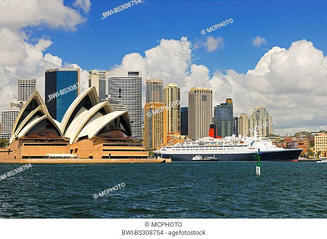 Queen Elizabeth 2 ocean liner and Sydney Opera in front of the skyline of Sydney, Australia, New South Wales, Sydney