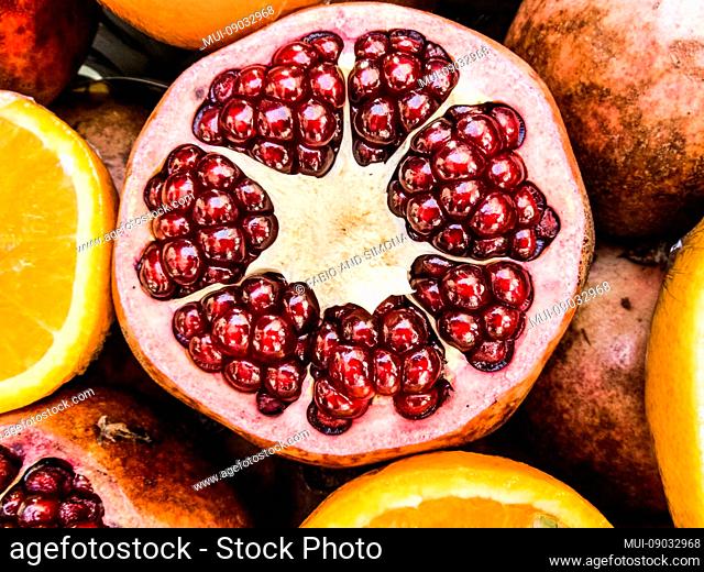 red close up of a pomegranate - season fresh healthy fruit for correct food alimentation like vegetarian and vegan concept