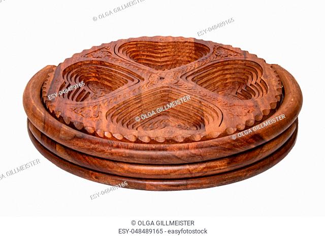Wooden bowls. Closeup of handmade hinged wooden bowl for fruits, vegetables and nuts isolated on a white background. Decorative souvenir from Malaysia