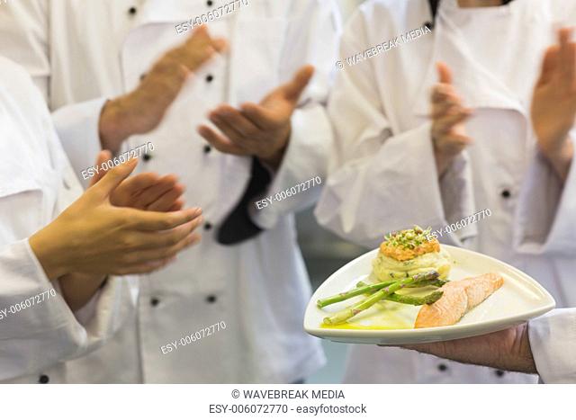 Chefs applauding a salmon dish