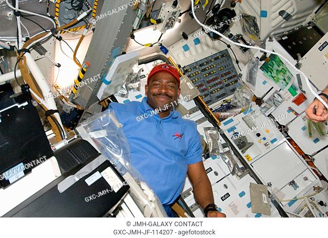 Astronaut Leland Melvin, STS-129 mission specialist, is pictured on the middeck of Space Shuttle Atlantis while docked with the International Space Station