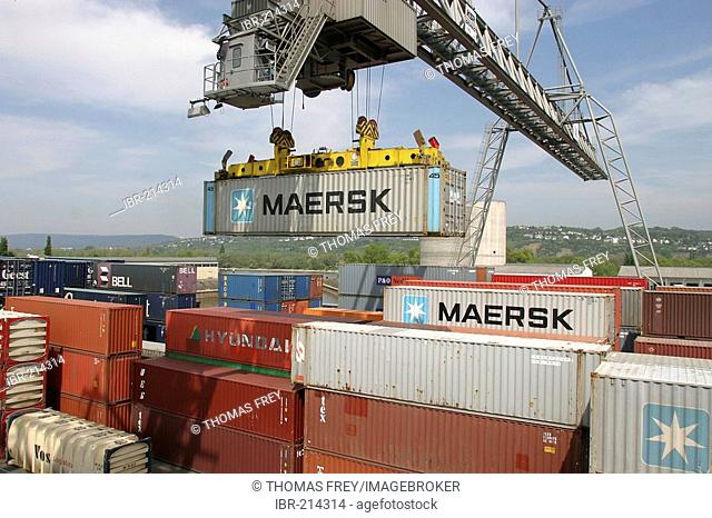 A gantry crane loading nestable containers . Koblenz, Rhineland-Palatinate, Germany