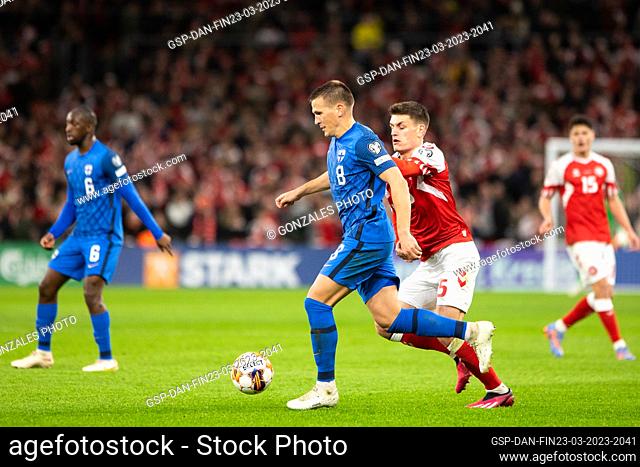 Copenhagen, Denmark. 23rd, March 2023. Robin Lod (8) of Finland and Joakim Maehle (5) of Denmark seen during the UEFA Euro 2024 qualification match between...
