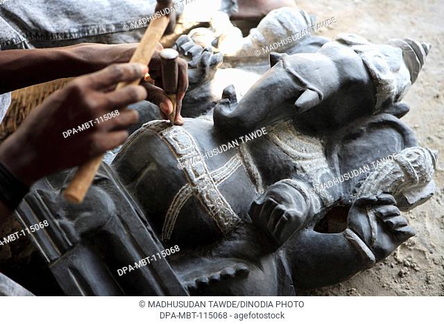 Local artist doing carving of Lord Ganesha at Shore temple complex ; Mahabalipuram ; District Chengalpattu ; Tamil Nadu ; India