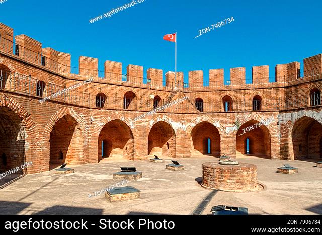 View of Alanya Red Tower in Antalya with orenge bricks, on bright blue sky background