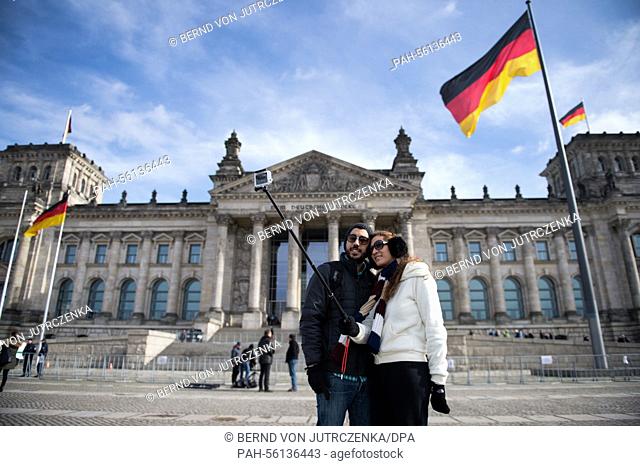 A young couple from Israel takes a picture of themselves by using a so called 'Selfie-Stick' in front of the German Reichstag in Berlin, Germany
