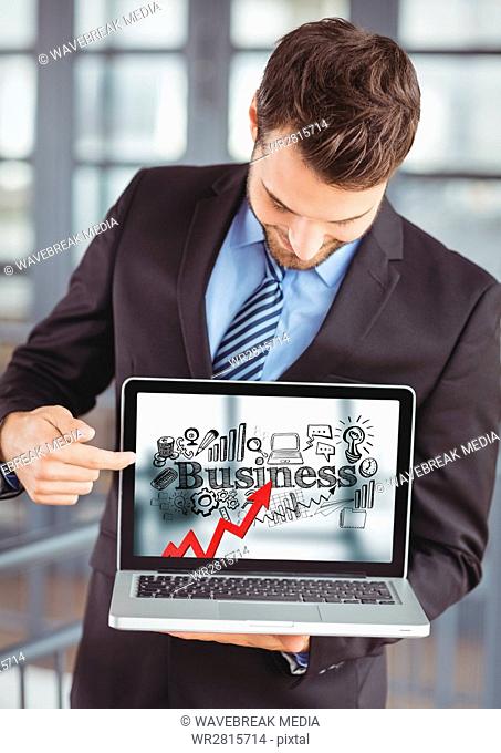 Business man holding laptop showing red arrow with black business doodles against blurry background