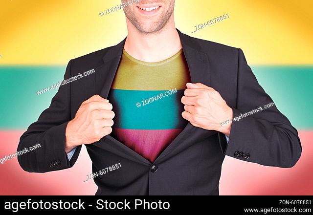 Businessman opening suit to reveal shirt with flag, Lithuania
