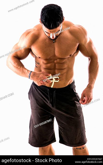 Handsome muscular and shirtless male using plicometer on white background