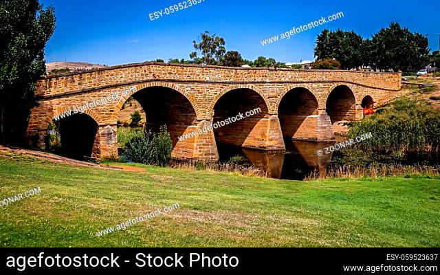 The iconic Richmond Bridge on bright sunny day. Richmond, Tasmania, Australia. Australia's oldest bridge made of stone was built in 1823