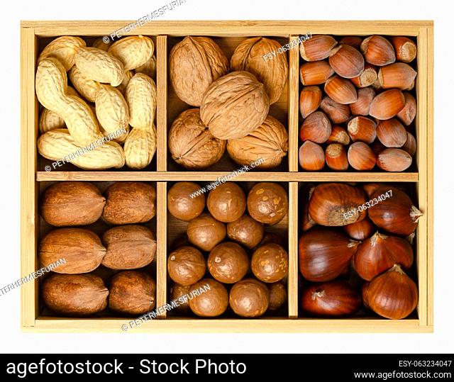 Mix of six different nuts in their shells, decorative assorted, in wooden box with compartments. Peanuts, walnuts, hazelnuts, pecans