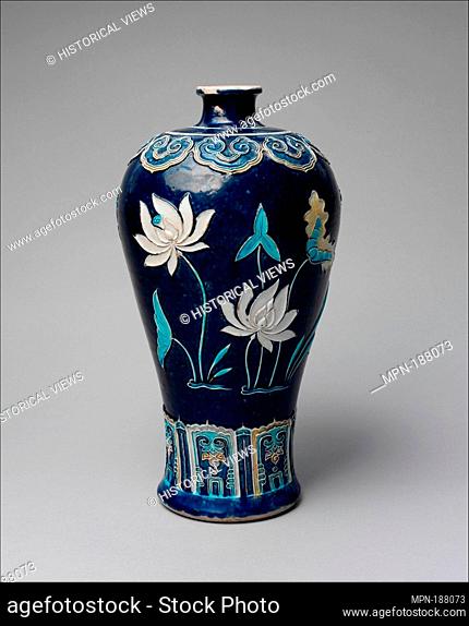 Bottle with Lotuses. Period: Ming dynasty (1368-1644); Date: late 15th century; Culture: China; Medium: Porcelain with raised slip and enamels (Jingdezhen...