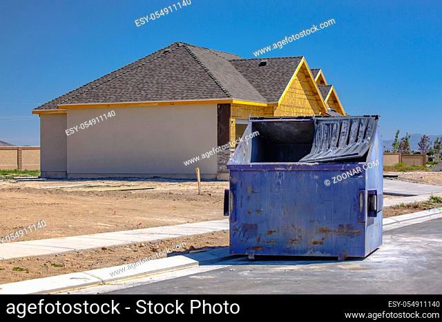 Dumpster sits outside of new construction home in Utah Valley