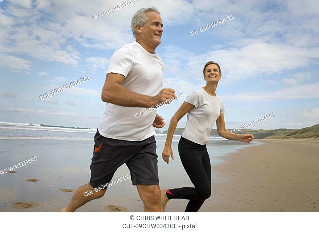 Couple running on a beach