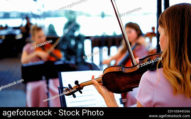 Musicians Two Violin And Cello Beautiful Girls Inspirationally Perform A Concert At Event Outdoor