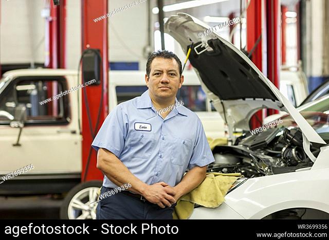 Portrait of Hispanic male mechanic in auto repair shop