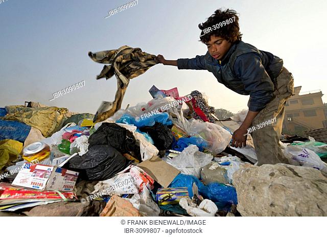 One of the children who live, play and work on the garbage dump at Bhagmati River in the middle of the city