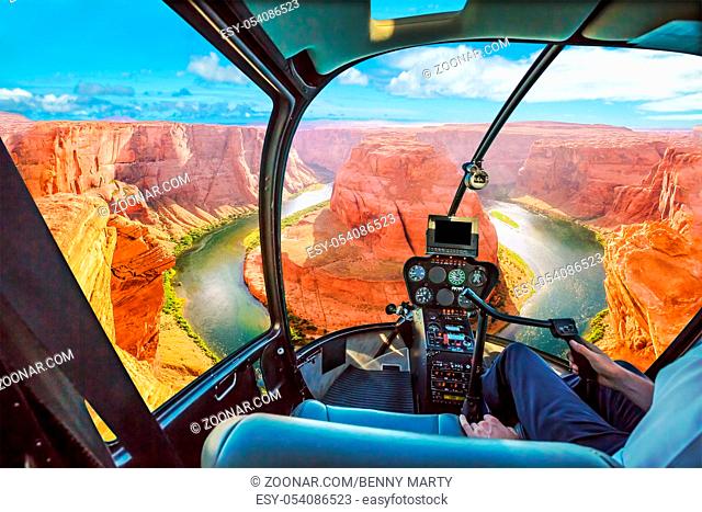 Helicopter cockpit scenic flight over Horseshoe Bend of Colorado River in Arizona, United States. Downstream from the Glen Canyon Dam and Lake Powell