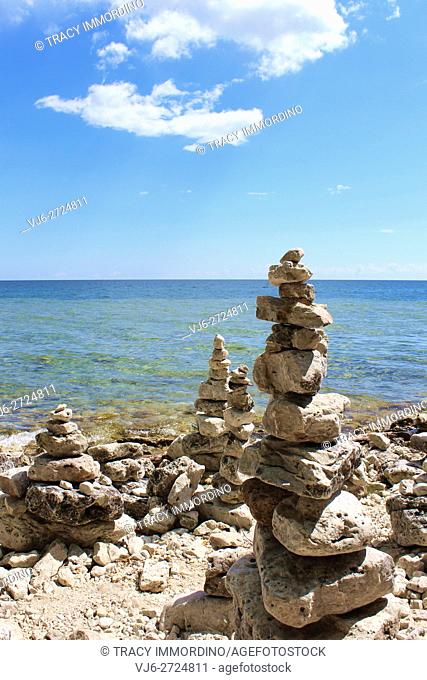 Multiple cairns, rock totems, on the rocky shoreline of Lake Michigan at Cave Point County Park, Sturgeon Bay, Door County, Wisconsin, USA
